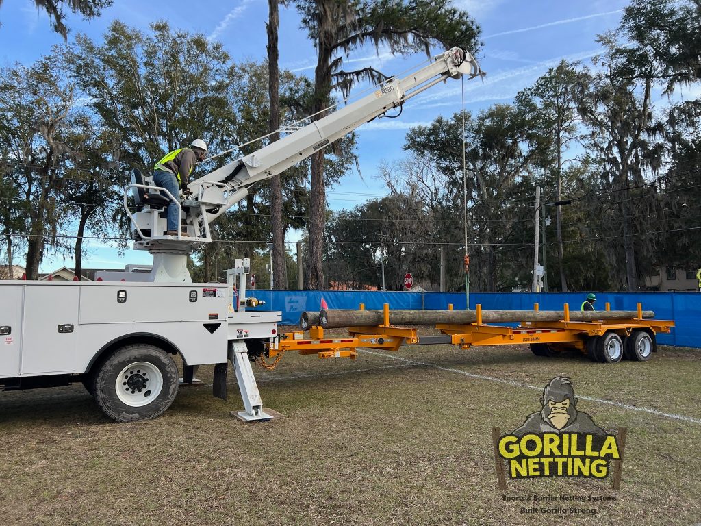 Pole installation for a soccer backstop.