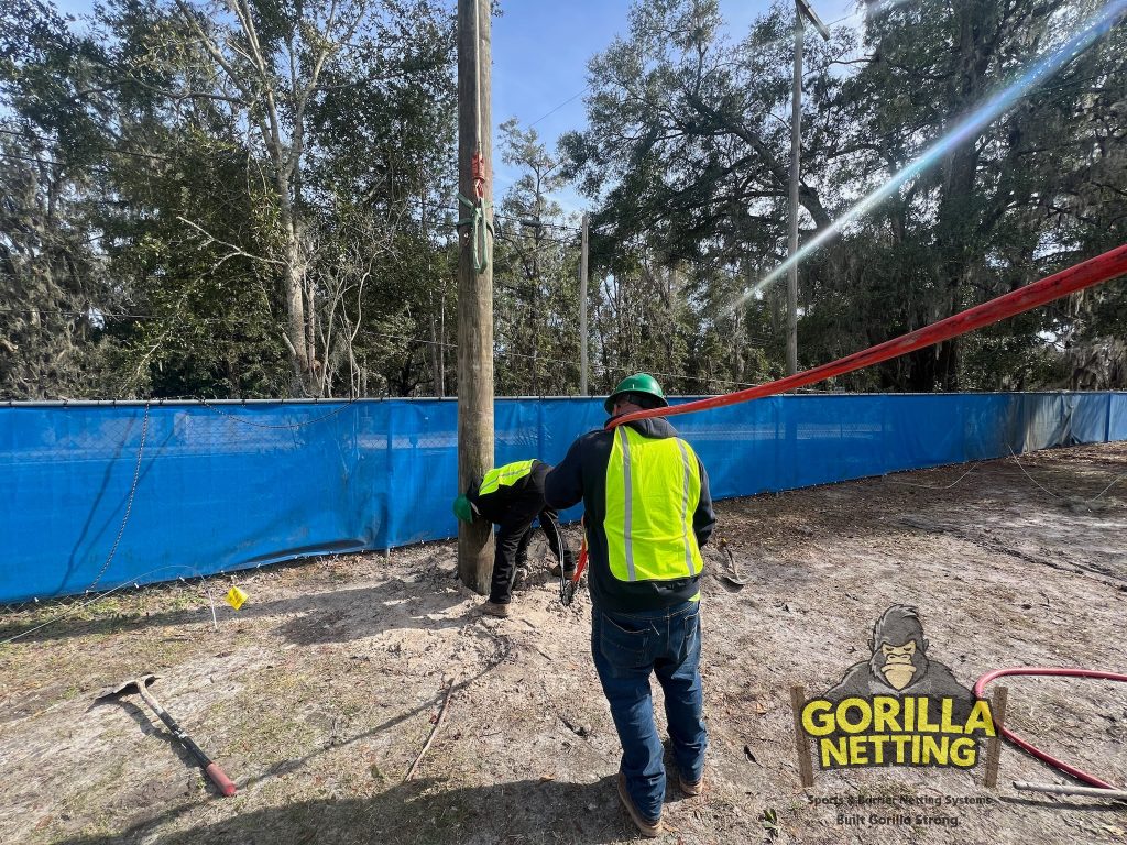Pole installation for a soccer backstop.